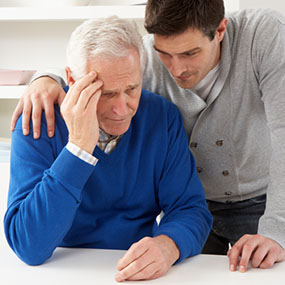 Grown Up Son Consoling Senior Parent