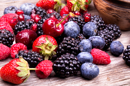 tasty summer fruits on a wooden table